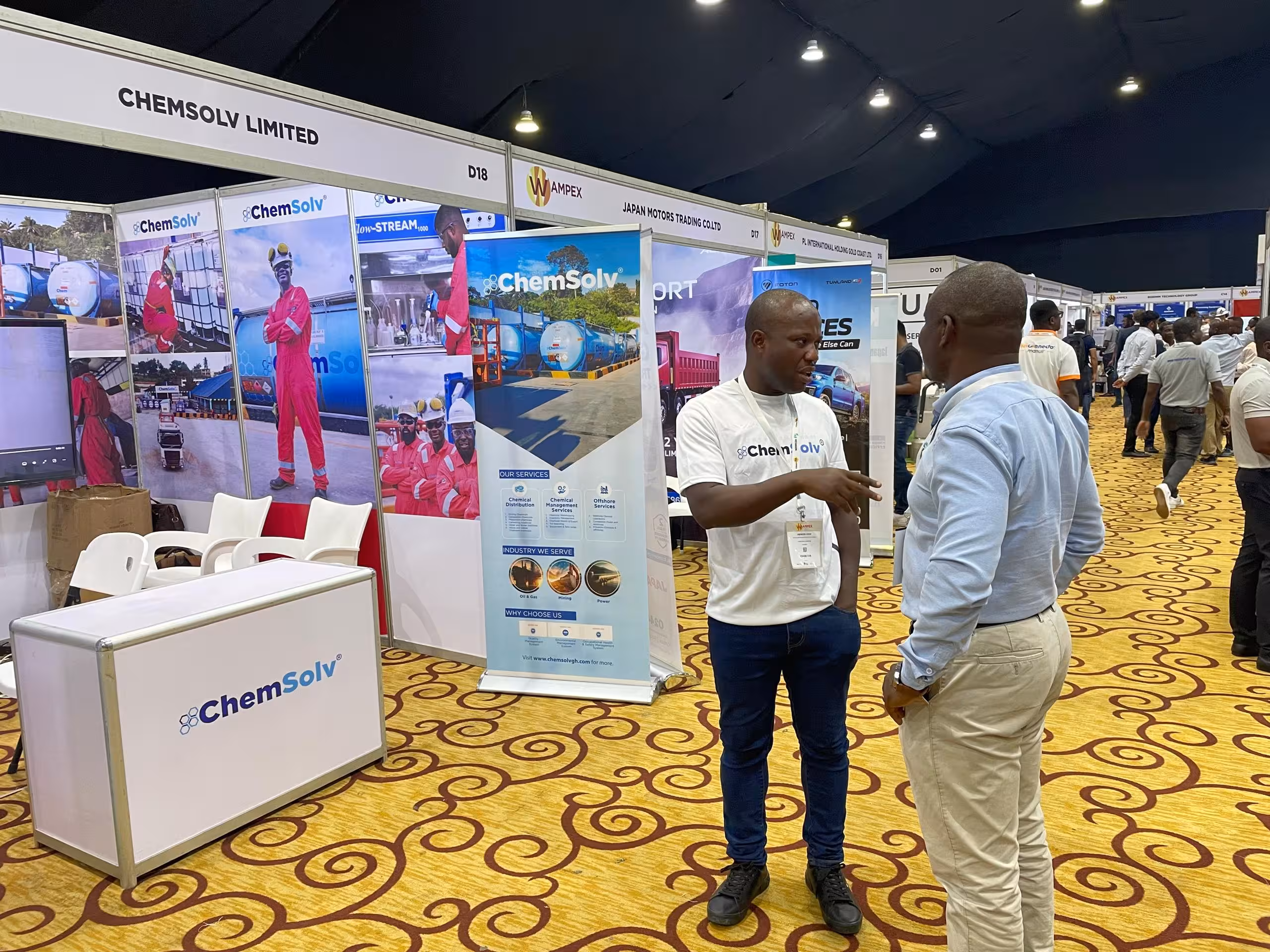 Two men have a conversation at an event